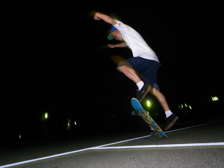 the man in the blue shorts is doing a trick on his skateboard