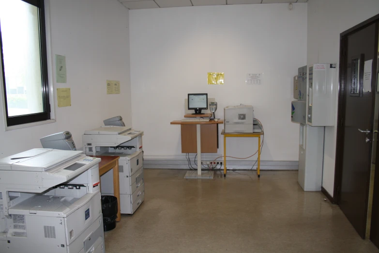 some computers on a desk with drawers and crates