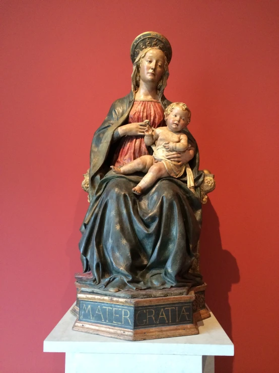 a statue of the virgin holding a baby