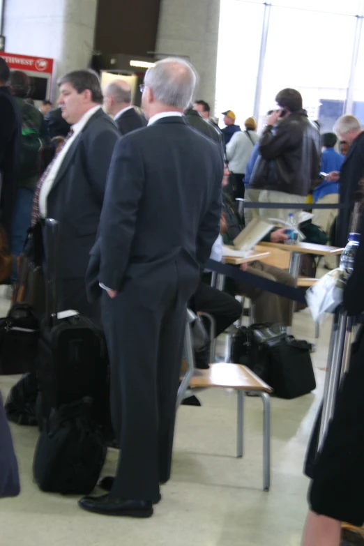 a man stands in a terminal near many other men