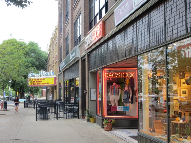 several shops line a street, with one storefront open