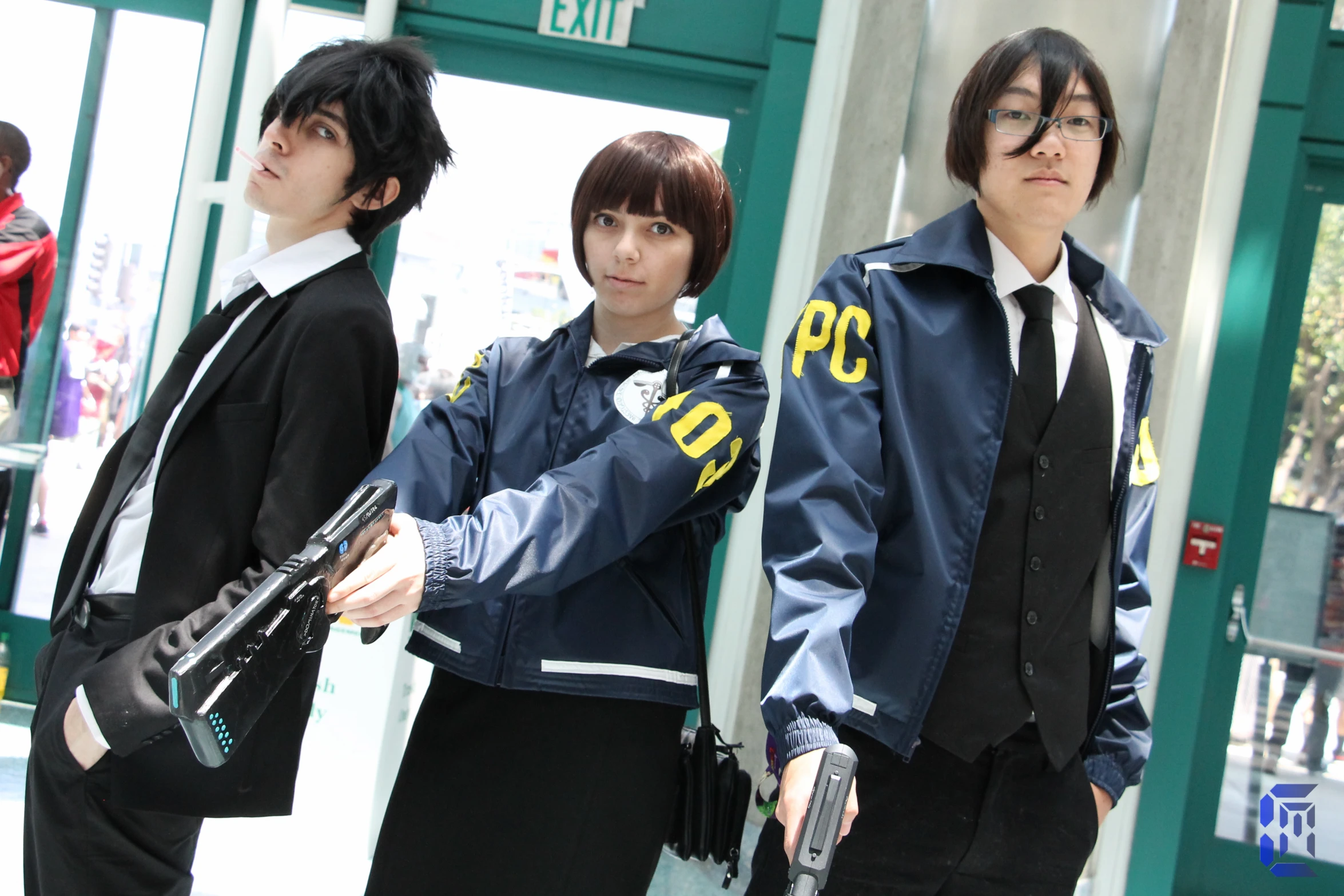three young people are dressed in uniforms standing outside