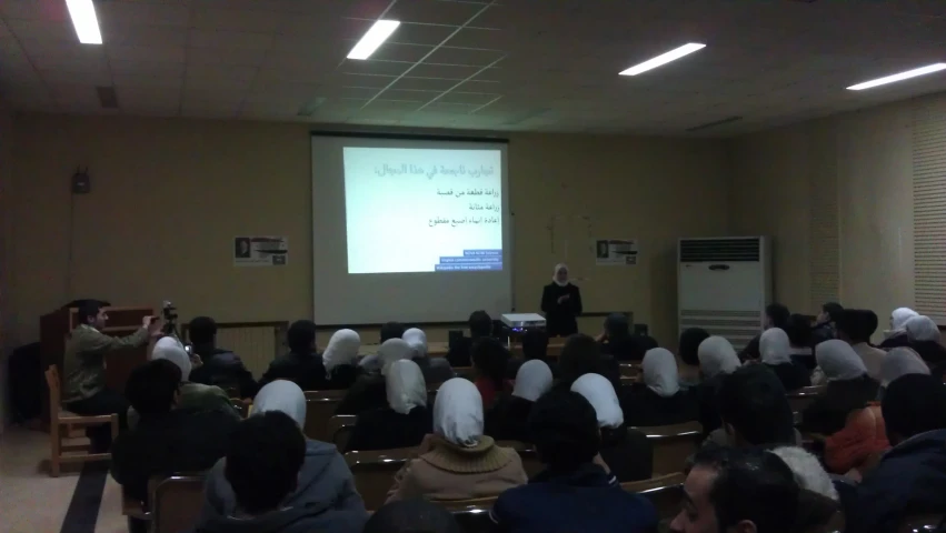 a person is giving a lecture at an open air meeting hall