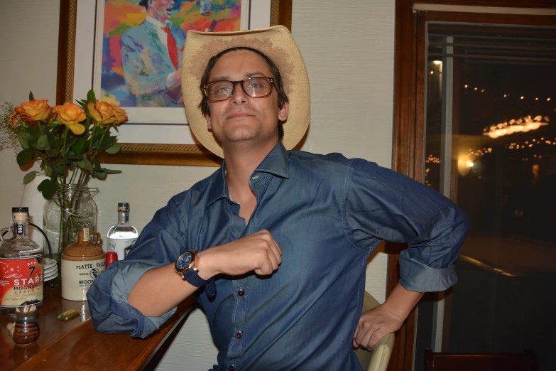 a man in a cowboy hat at a bar