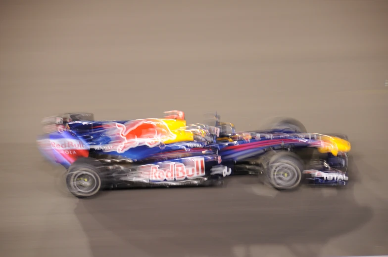 a red bull racing car in motion on a track