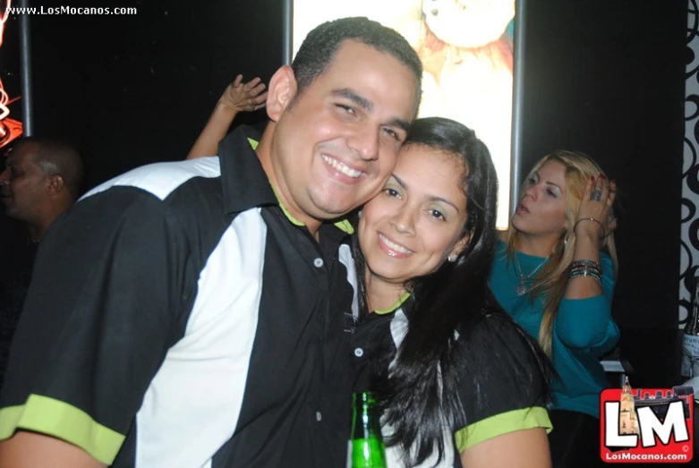 two people in black and white shirts emcing at a party