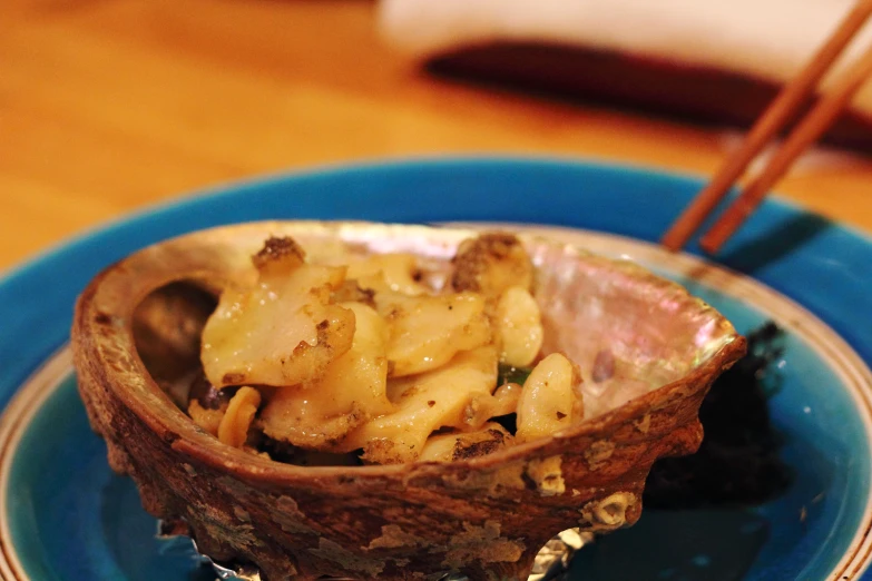 the bowl is filled with noodles and meat