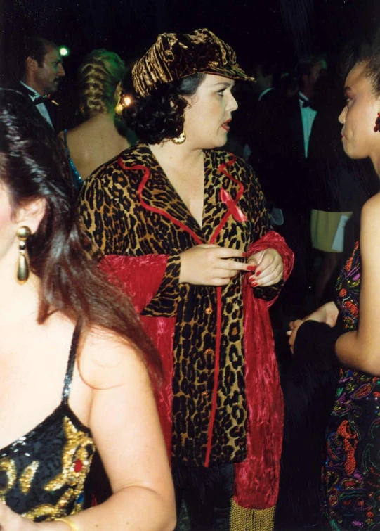 a lady in a leopard print costume is standing with other women