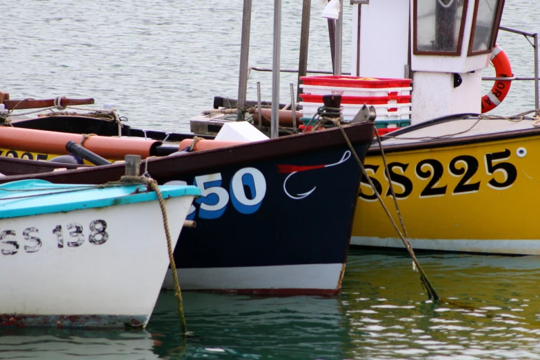 two boats sitting docked next to each other