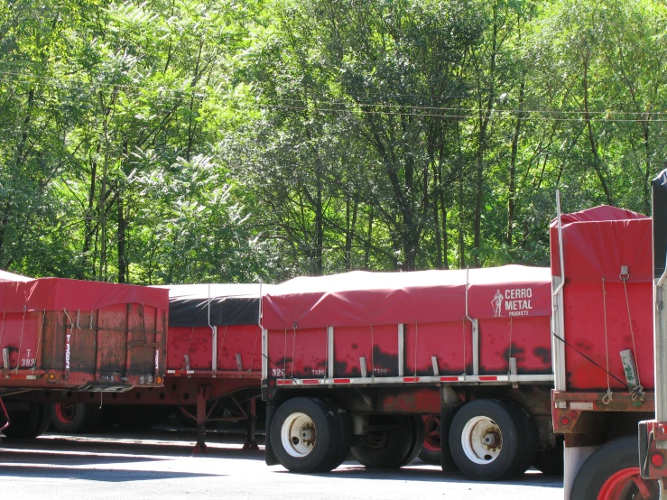 a truck carrying several large trailers down a road