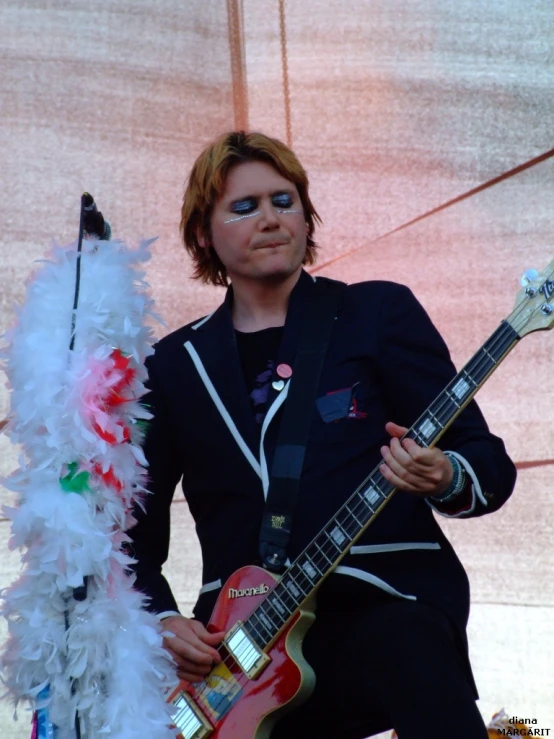 a woman in black and white playing a guitar