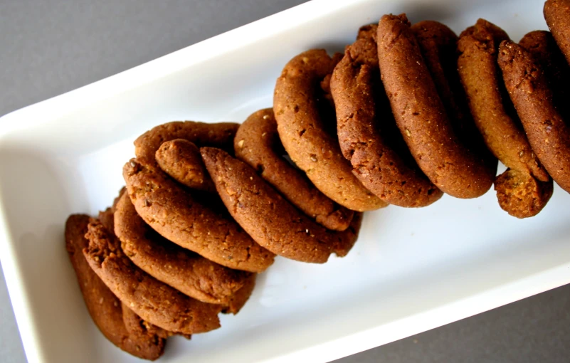 a white plate of cookies on top of a table