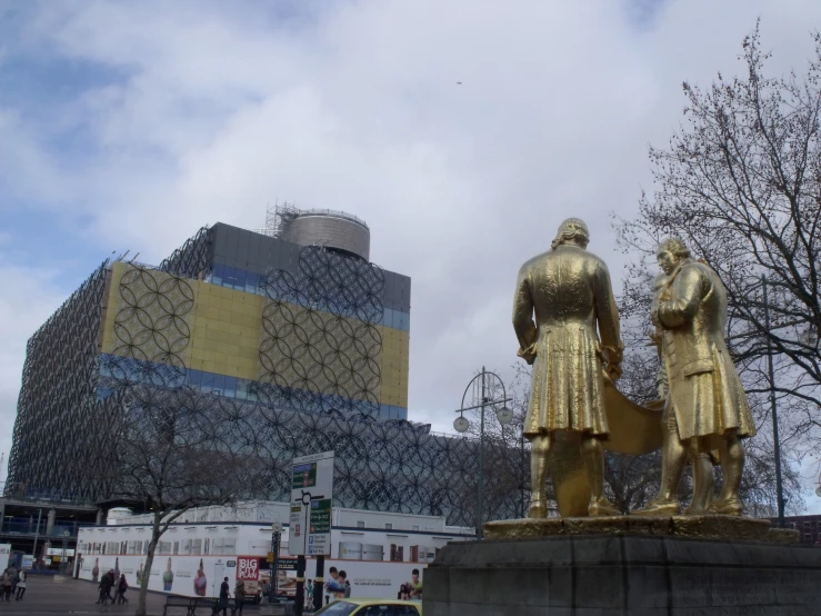 a view of some gold statues outside of a building