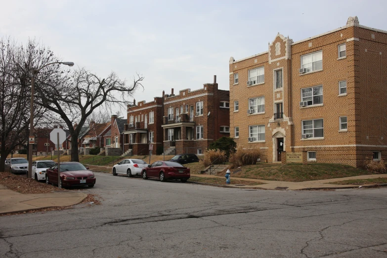 two row homes on street with cars parked in front