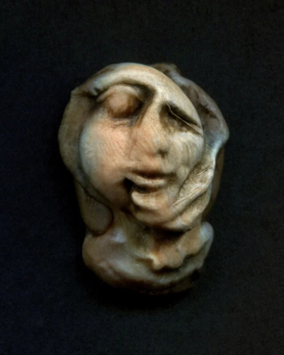 an abstractly carved ceramic sculpture of a woman