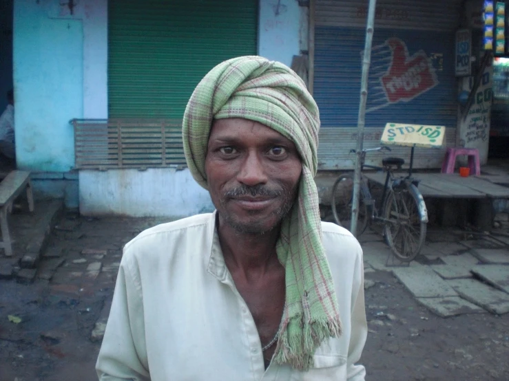 a man with a turban on a street in india