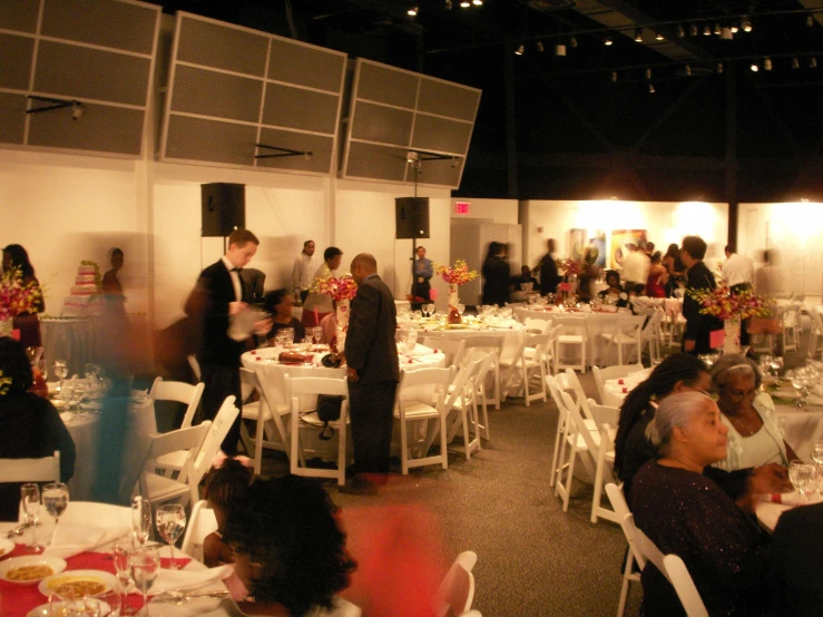 many people dining at a banquet table in a building