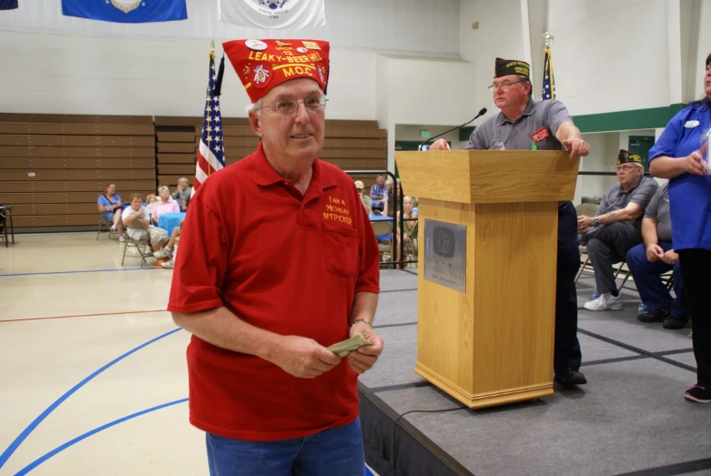 a man in a red uniform and a speaker