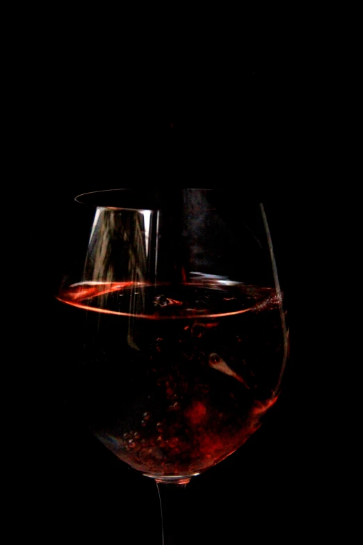 a wine glass with red wine in it