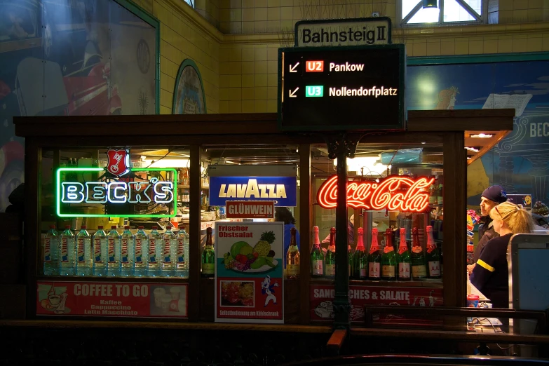 a soda machine in a restaurant with signs on the doors