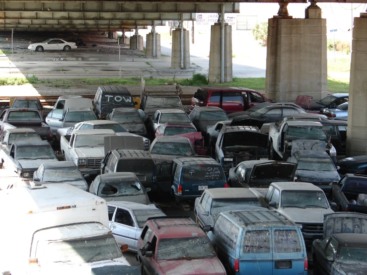 a bunch of cars are parked in an open lot