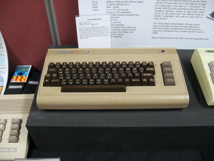 there is an old typewriter next to other electronic objects