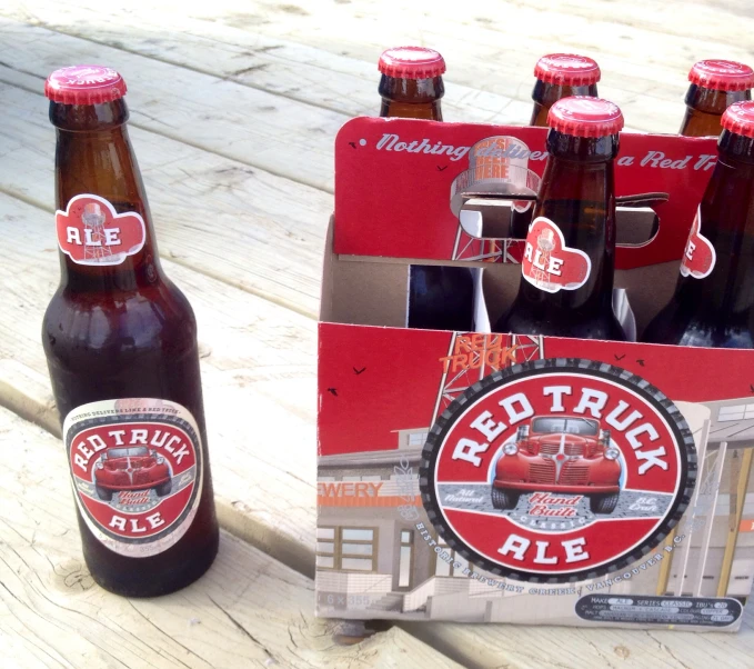 several red truck beers sitting on a table