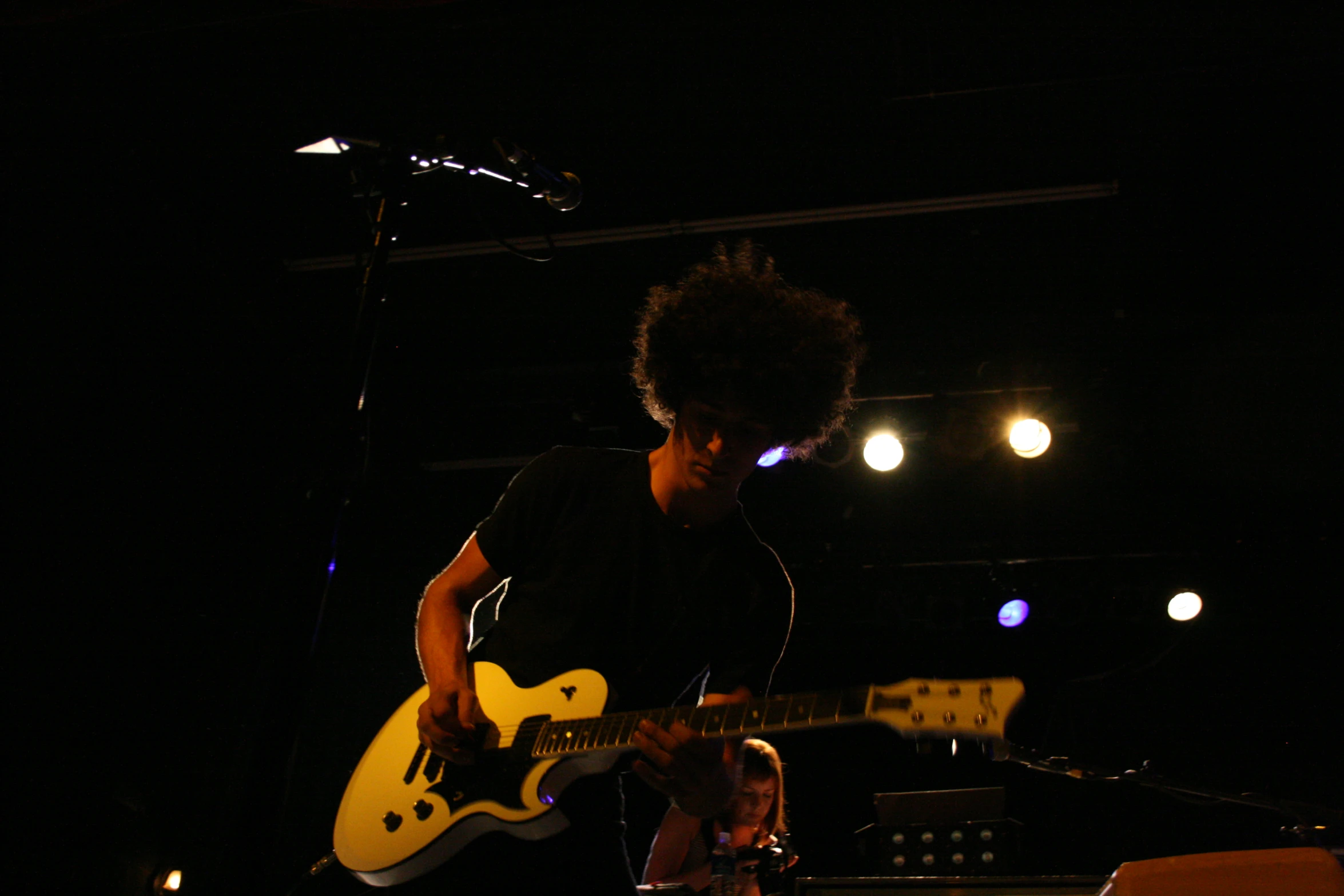 a person is playing a guitar on stage