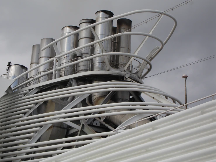large metal tanks on top of a white building