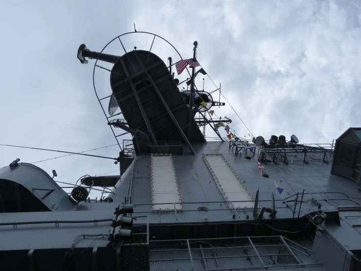 a large battleship has flags and other items on it