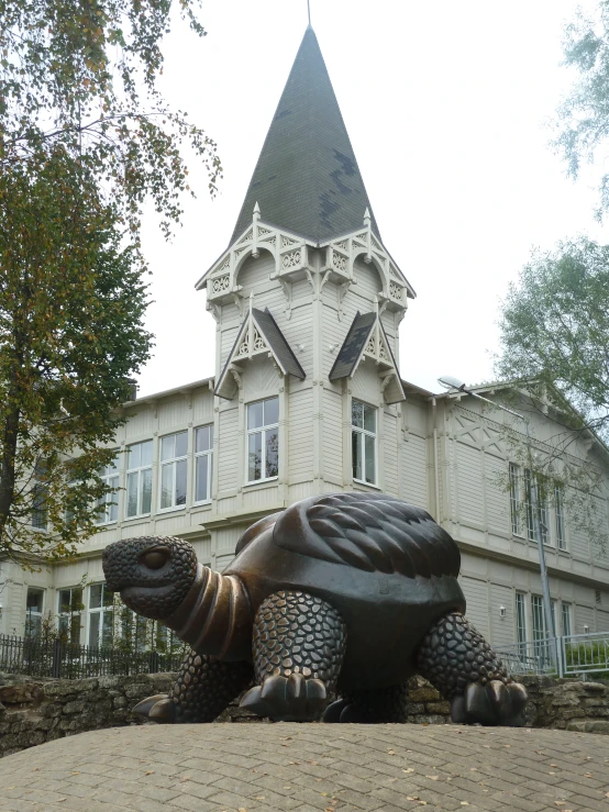 an ornate house with a giant turtle statue outside