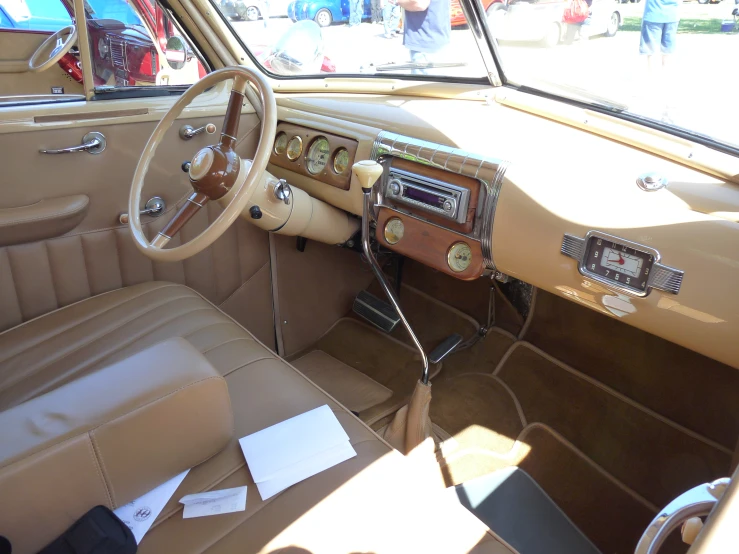 interior of a brown vintage car with a brown dashboard