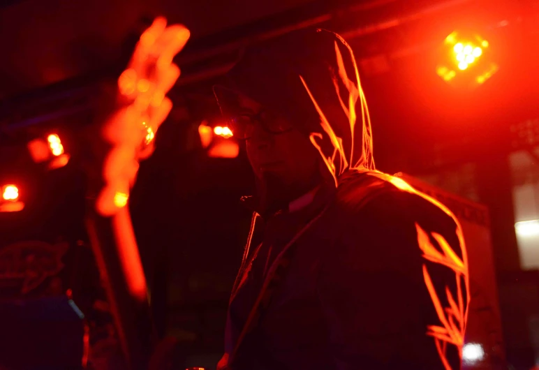 the guitarist stands alone on the stage at night