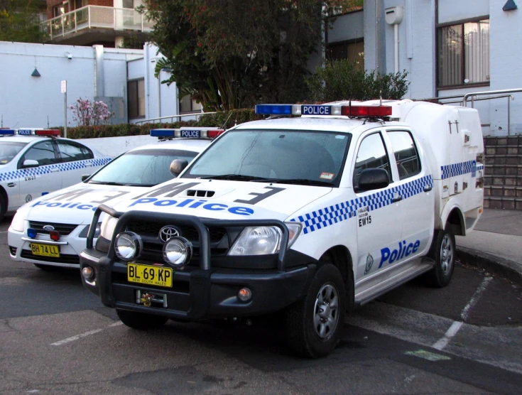 two police officers parked next to a white van