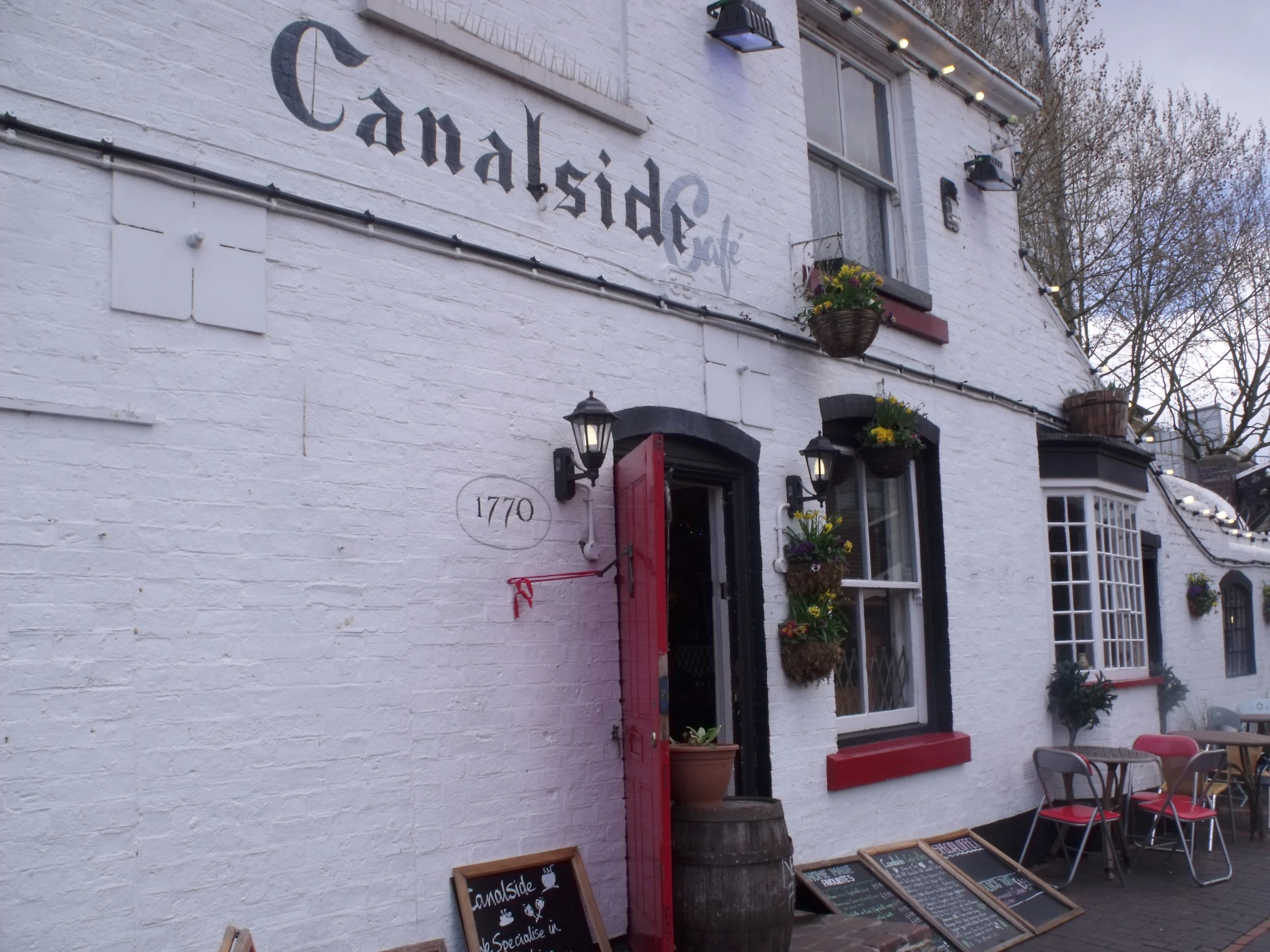 an exterior view of a restaurant with white brick