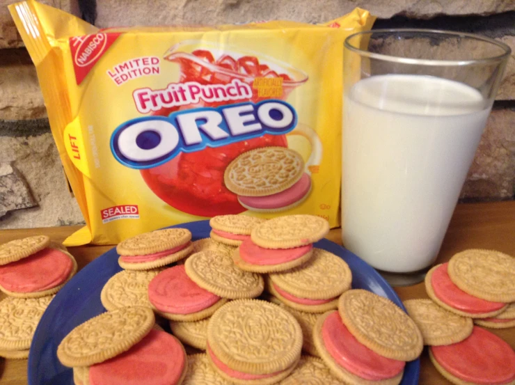 a pile of cookies on a table next to a glass of milk