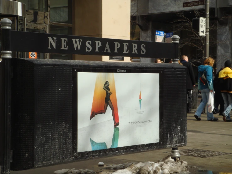 a newspaper dispenser is set up on the side of a street