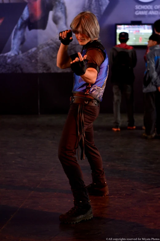 a man in a costume holding a gun while standing on the floor