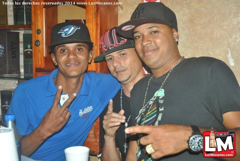 three men posing for the camera at a restaurant