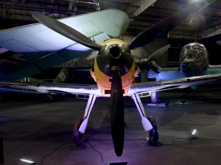 a large propeller airplane in a hanger at an airport