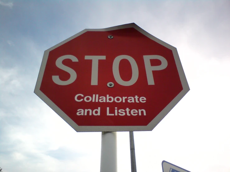 a red stop sign with the word collaborate and listen written on it