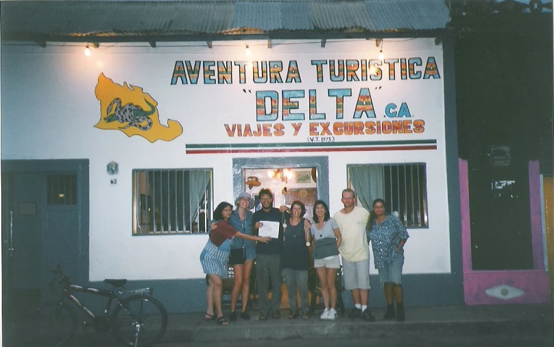 a group of people standing outside of a store