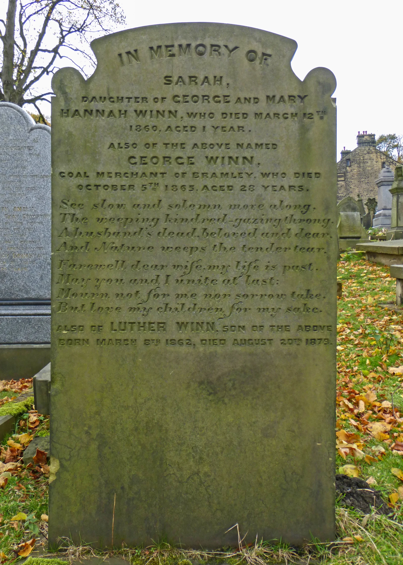 a tombstone is in front of some headstones