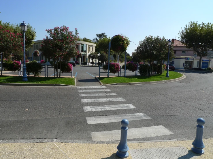 a street corner with three blue poles on the side of it