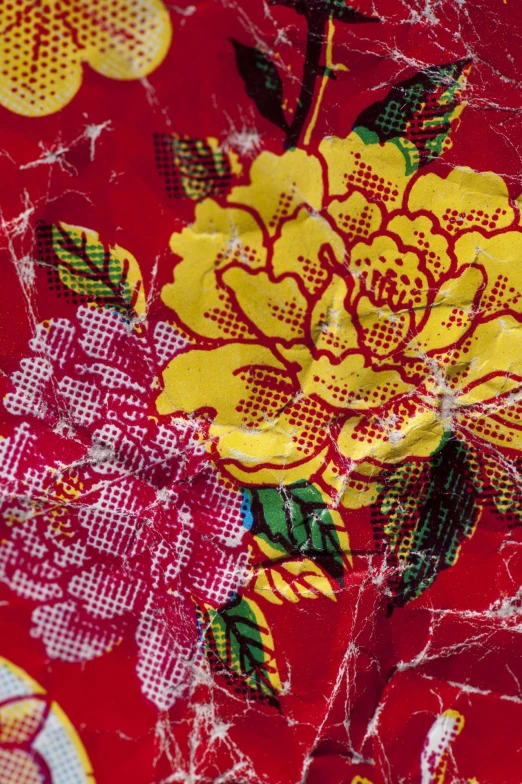 an artistic red floral fabric with yellow flowers