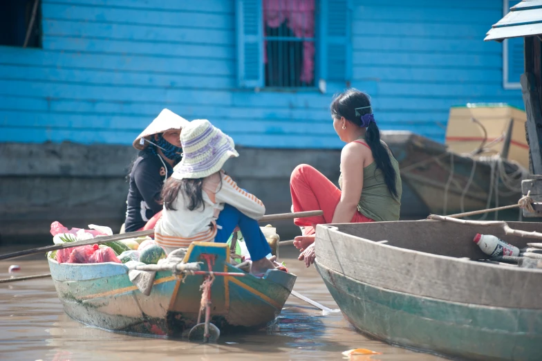 two girls are riding in the boat on the water