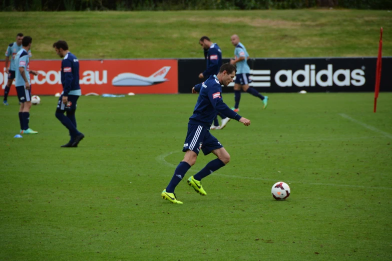 soccer player kicking the ball during a game