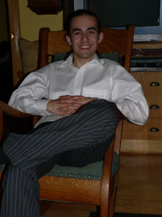 a man wearing a white shirt and gray pants