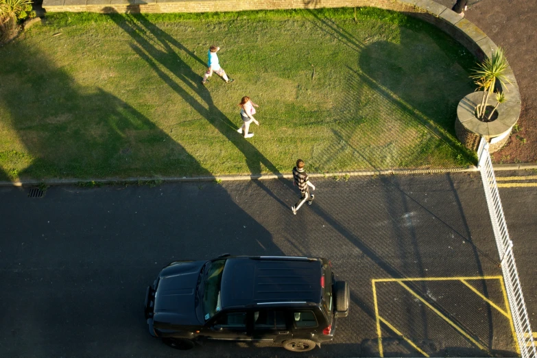 two men are walking toward the black car