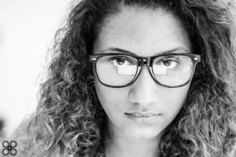 woman in black and white with glasses staring